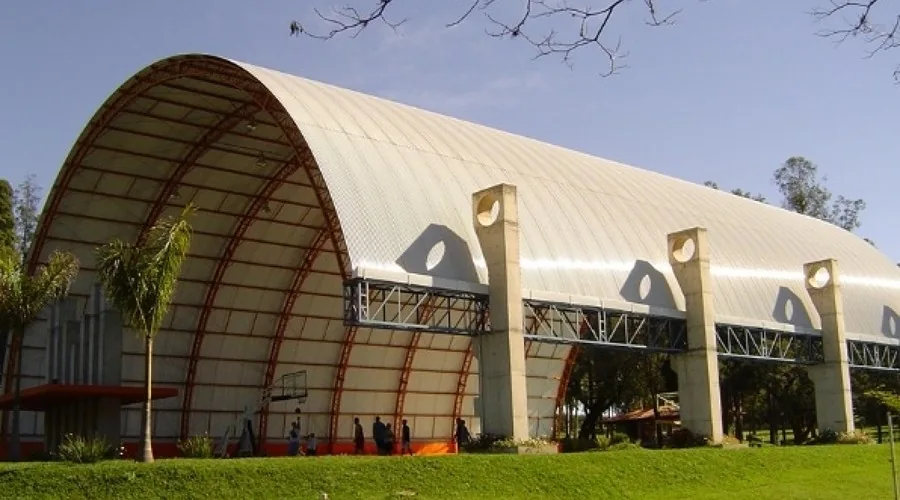 Ginásio ou espaço coberto com grande cobertura metálica arqueada